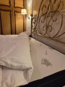 a close up of a bed with white sheets at Holy family in Pachino