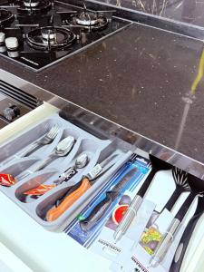 a drawer filled with utensils in a kitchen at Résidence jawhret el kram in El Aouina Station