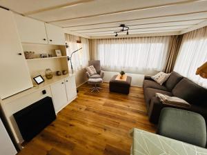 a living room with a couch and a chair at Hofquartier Greven in Greven