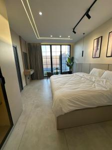 a bedroom with a large white bed in a room at TRIO Chalet 1 in Sowayma +41 photos