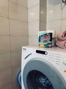 a washing machine with a box of chips on a counter at Apartman Amela in Mostar