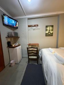 a bedroom with a bed and a tv on the wall at Amani Nest in Arcadia