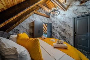 a bedroom with a large bed with yellow pillows at Qafqaz Cabana Chalet in Gabala +66 photos