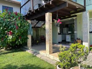 a patio of a home with a deck with flowers at Espaço Aconchego in Pomerode