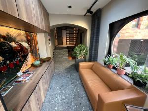 a living room with a couch and some plants at Gleisbett 12-3 in Meiningen