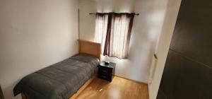 a small bedroom with a bed and a window at Casa Misiones 1 in El Espino