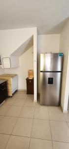 a large kitchen with a stainless steel refrigerator at Casa Misiones 1 in El Espino