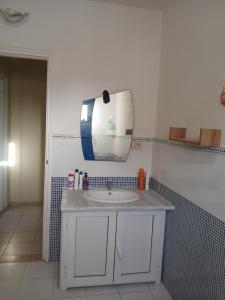 a bathroom with a sink and a mirror on the wall at Dar Cally Maison d Artiste in Midoun +31 photos