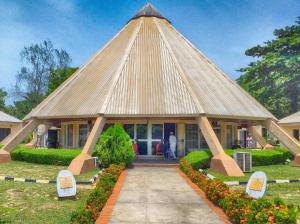 a pavilion with a large roof in a yard at Green Palm Resort Lekki in Ikuata