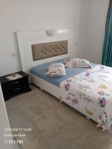 a bedroom with a bed with two pillows at Dar MORTADA TATAOUINE in Tataouine