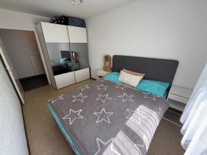 a bedroom with a bed and a large mirror at Cosy Place in Monthey