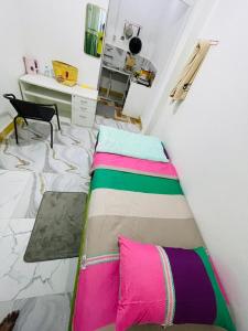 a bed in a small room with a bed sidx sidx sidx at Sunmoon Apartment in Deli