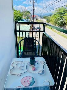 a table on a balcony with a coffee cup on it at Sunmoon Apartment in Deli