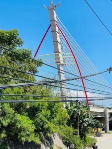 a suspension bridge with red paint on it at Sunmoon Apartment in Deli +4 photos
