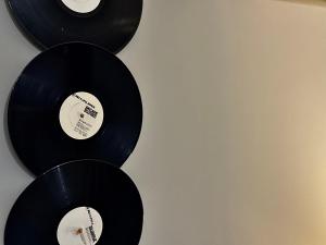 a group of black records hanging on a wall at Spin Inn in Kotor +27 photos