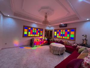 a living room with a couch and stained glass windows at Villa ETAHIRI in Marrakesh
