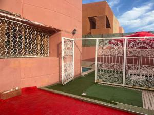 a building with a gate in front of a building at Villa ETAHIRI in Marrakesh