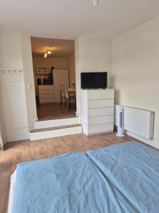 a bedroom with a bed and a television and a table at Ferienwohnung Einfeld in Neumünster
