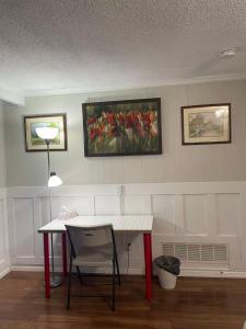 a room with a table and a painting on the wall at Arkona Home in Toronto