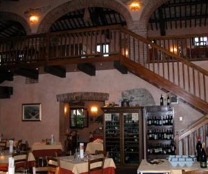 a dining room with a staircase in a restaurant at Da Nicola in Montegrotto Terme