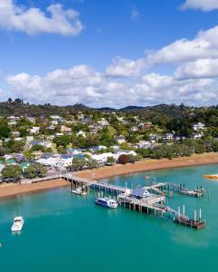 an aerial view of a dock and a beach with boats at Wisteria Villa in Russell