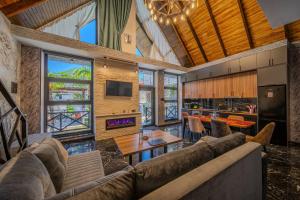 a living room with a couch and a table at Qafqaz Cabana Chalet in Gabala