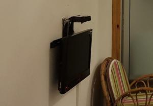 a television hanging on a wall in a room at Rittoo Complex -Gavnor in Quatre Bornes