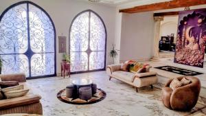 a living room with two large windows and a couch at Alf Layla Resort in Cairo