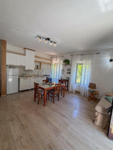 a kitchen and living room with a table and chairs at Nima in Porto Santo Stefano