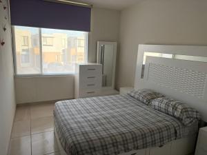 a bedroom with a bed and a large window at Casa en zona industrial SLP in San Luis Potosí +24 photos
