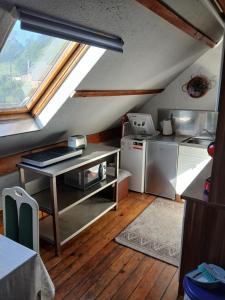 a kitchen with a stove and a sink and a window at Penzion Jakuby in Děčín