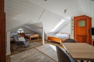 a room with two beds and a table and chairs at Villa Baltica in Łeba +46 photos