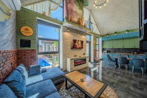 a living room with a couch and a fireplace at Qafqaz Retro Bungalow in Gabala
