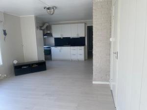 a kitchen with white cabinets and a tile floor at Best place to live in Trondheim