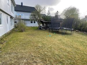 a yard with two ping pong tables and a house at Best place to live in Trondheim