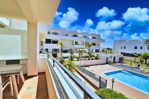 a view of the pool from the balcony of a hotel at Apartamento Cañada Honda Conil in Conil de la Frontera