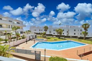 a large swimming pool in front of a building at Apartamento Cañada Honda Conil in Conil de la Frontera
