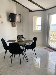a dining room with a table and chairs and a television at Apartment Eleni in Šibenik