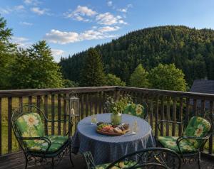 a table with a bowl of fruit on a deck at Chalet SCHNEEHASE 10min - Kreischberg in Stadl an der Mur