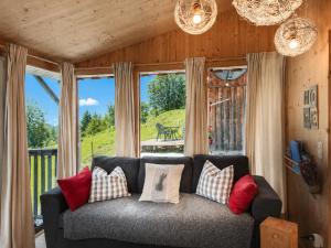 a living room with a couch in front of a window at Chalet SCHNEEHASE 10min - Kreischberg in Stadl an der Mur