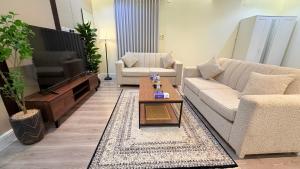 a living room with a couch and a coffee table at الجوهره حائل in Hail +2 photos