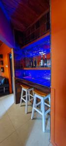 a bar with two stools and a blue bar at Mukani B&B in Lobatse