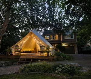 a large yellow tent in front of a house at Near The City Tent in Sainte-Catherine