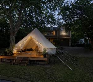 a large white tent in front of a house at Near The City Tent in Sainte-Catherine