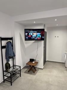 a room with a flat screen tv on the wall at Hera in Verga Kalamata