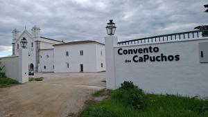 a white building with a sign that readsconservatory of the cariots at A Casinha in Portel +2 photos