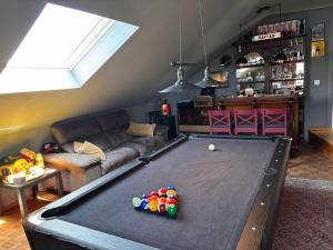 a living room with a pool table in the middle at Selma hosts Tomorrowland 2026 in Duffel