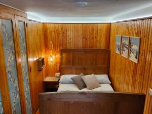 a bedroom with a bed in a wooden wall at La baita alpina in Scopello
