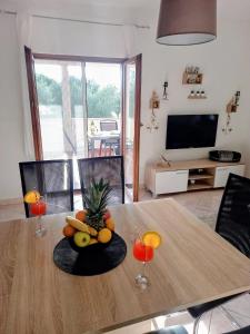 a table with a bowl of fruit on top of it at Vacation Home Katarina in Nin