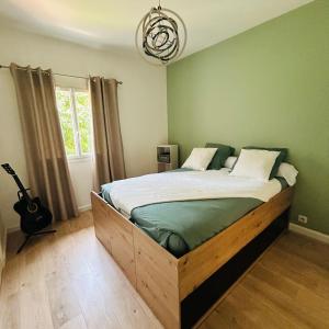 a bedroom with a bed with a wooden frame at Villa Sunlight Mougins in Mougins +30 photos